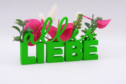 LiebeDeluxe® 3D-Aufsteller mit „Alles Liebe“-Schriftzug in Grün, mit Öffnungen für Blumen oder Geldscheine