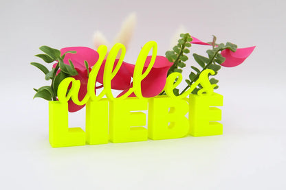 LiebeDeluxe® 3D-Aufsteller mit „Alles Liebe“-Schriftzug in Neon Gelb, mit Öffnungen für Blumen oder Geldscheine