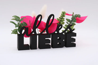 LiebeDeluxe® 3D-Aufsteller mit „Alles Liebe“-Schriftzug in Schwarz, mit Öffnungen für Blumen oder Geldscheine