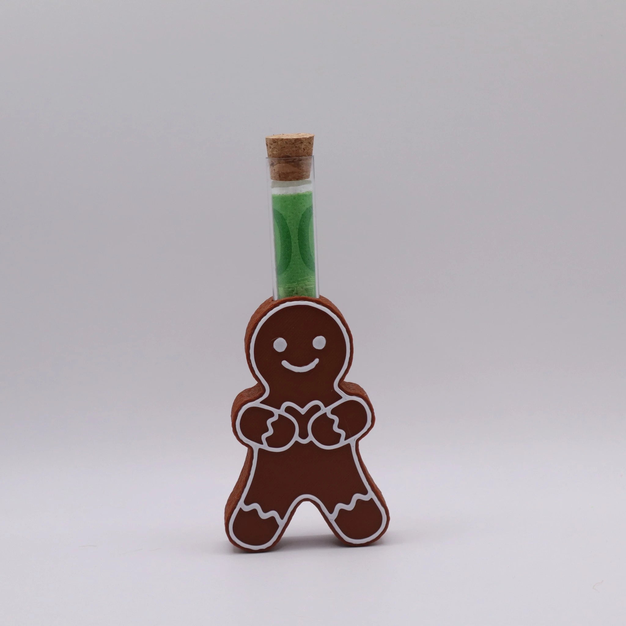 Lebkuchenfigur GingerHeart mit Herz und Reagenzglas – handgemachtes 3D-Druck-Geldgeschenk in Lebkuchen-Braun mit weißem Zuckerguss.
